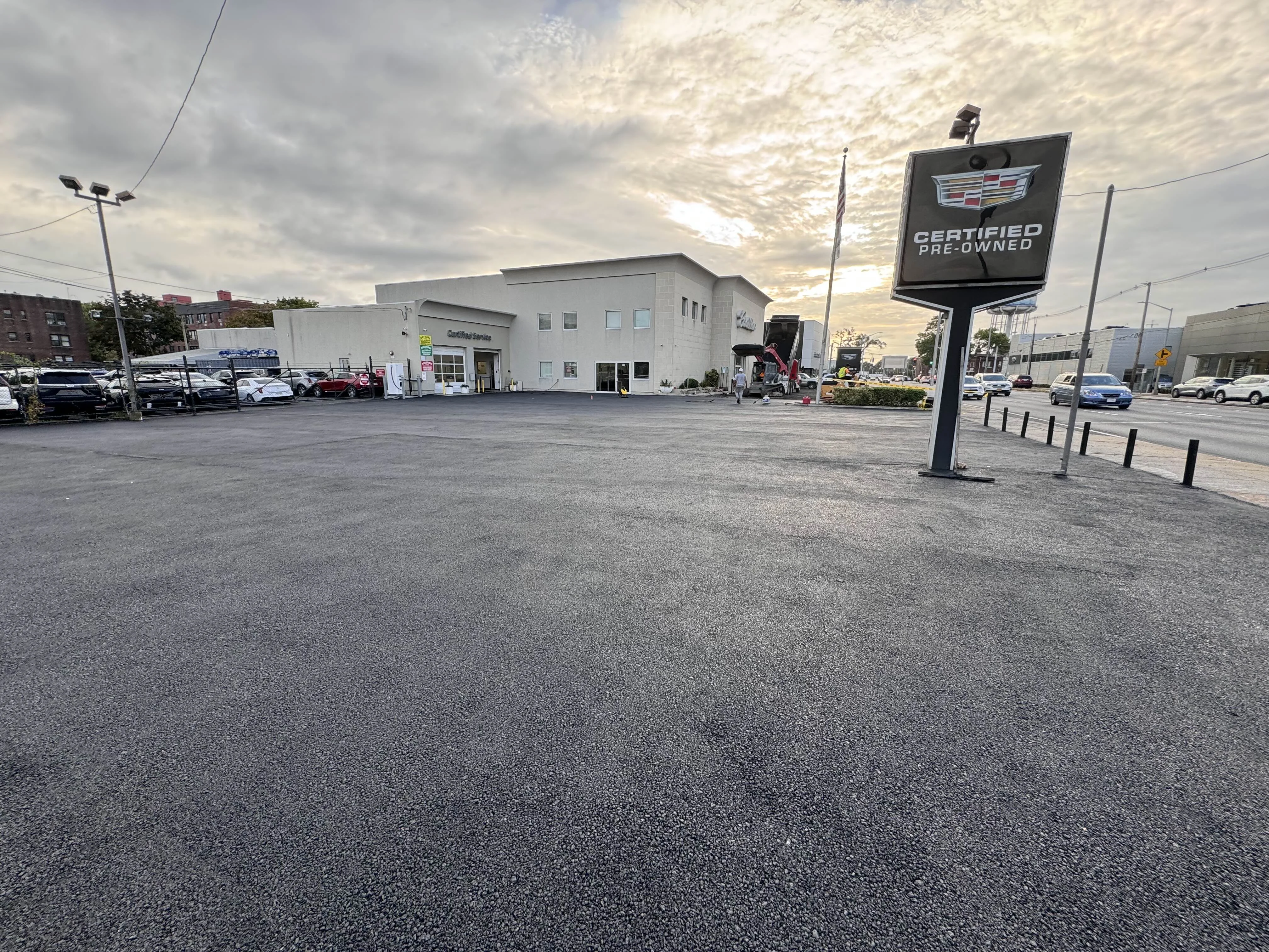 Completed asphalt parking lot at Paul Conte Cadillac dealership in Nassau County