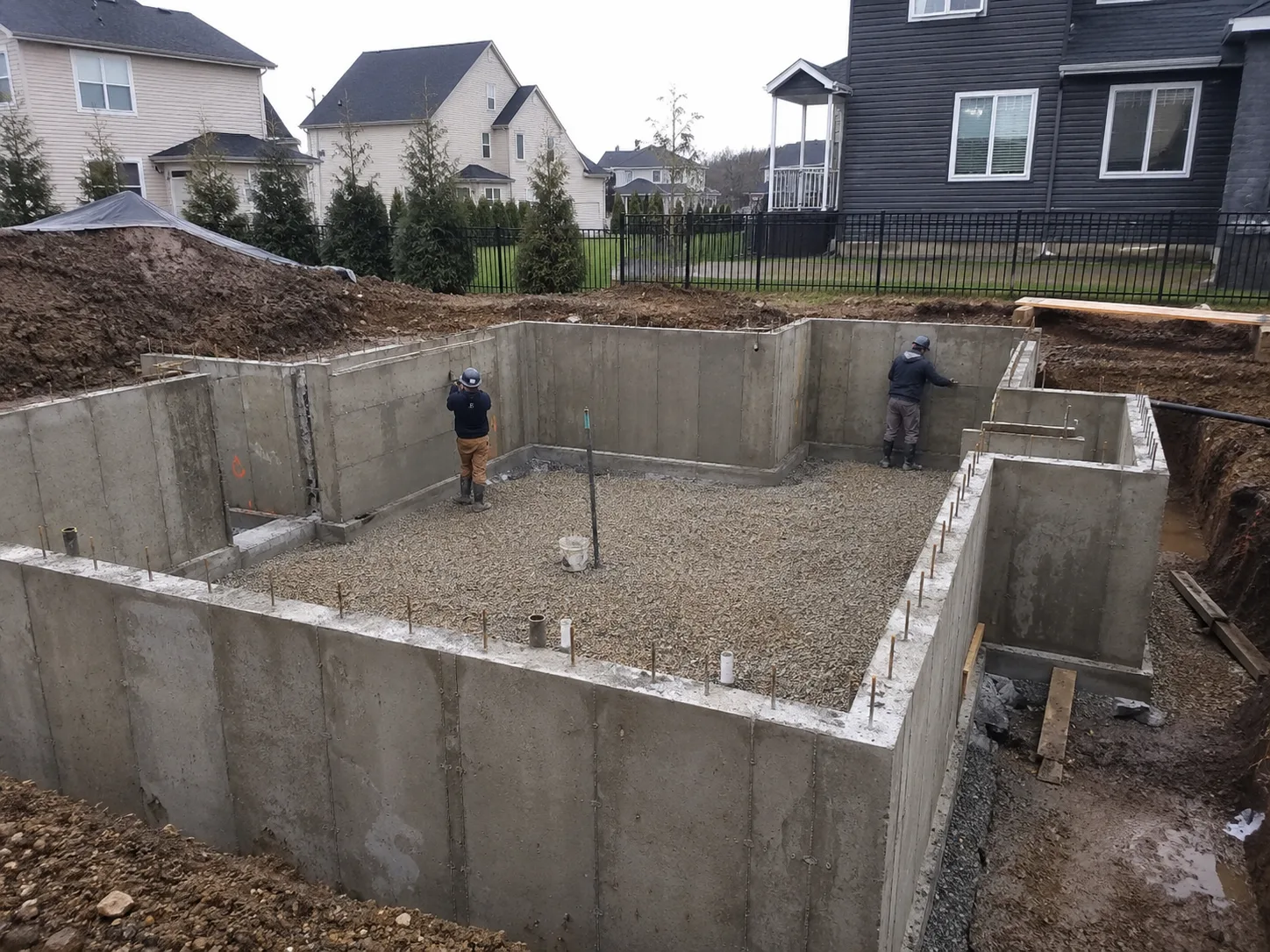 Precision Concrete crew finishing concrete foundation walls at a New York residential build