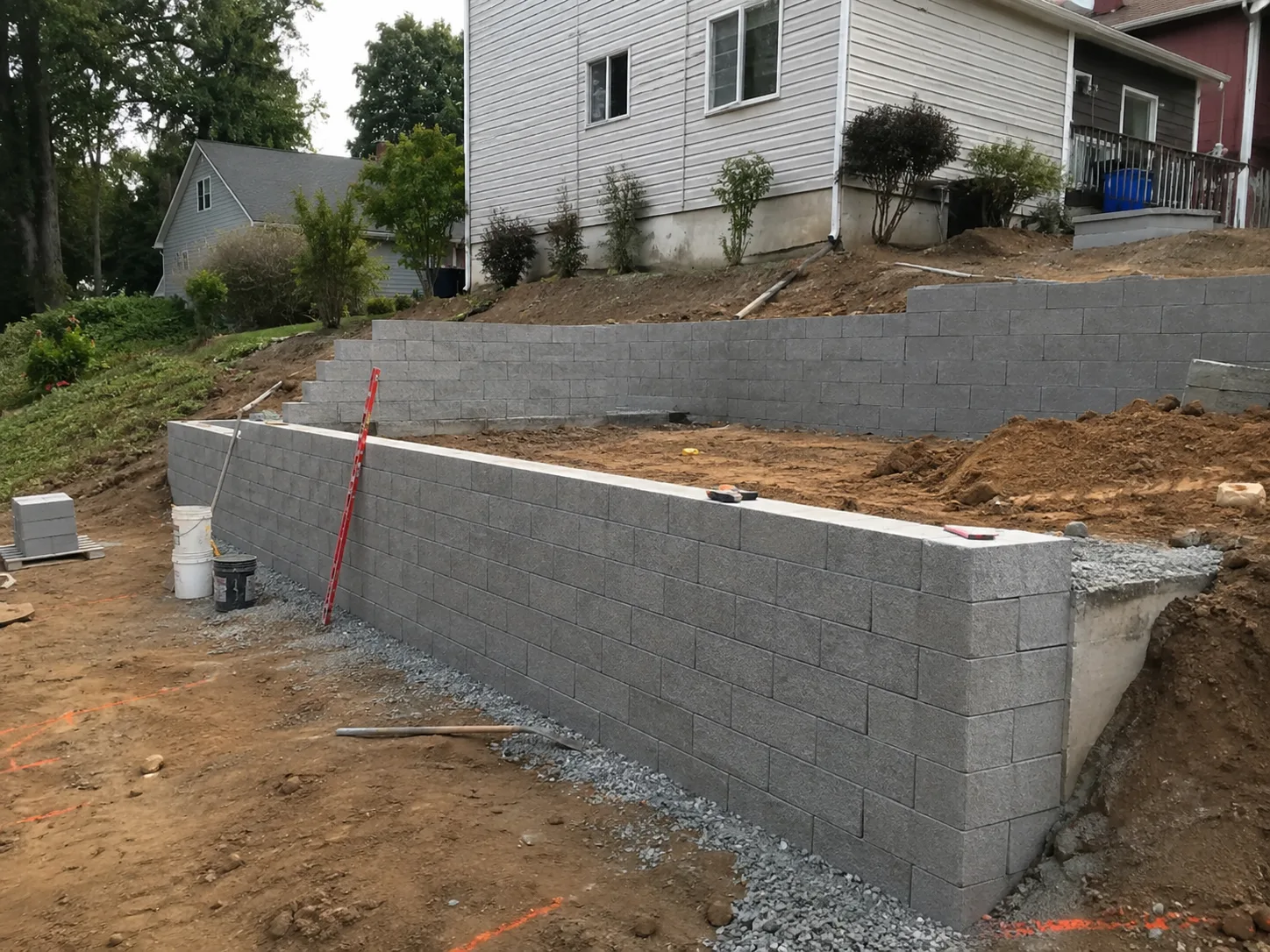 Terraced concrete block retaining walls under construction at a residential slope in New York
