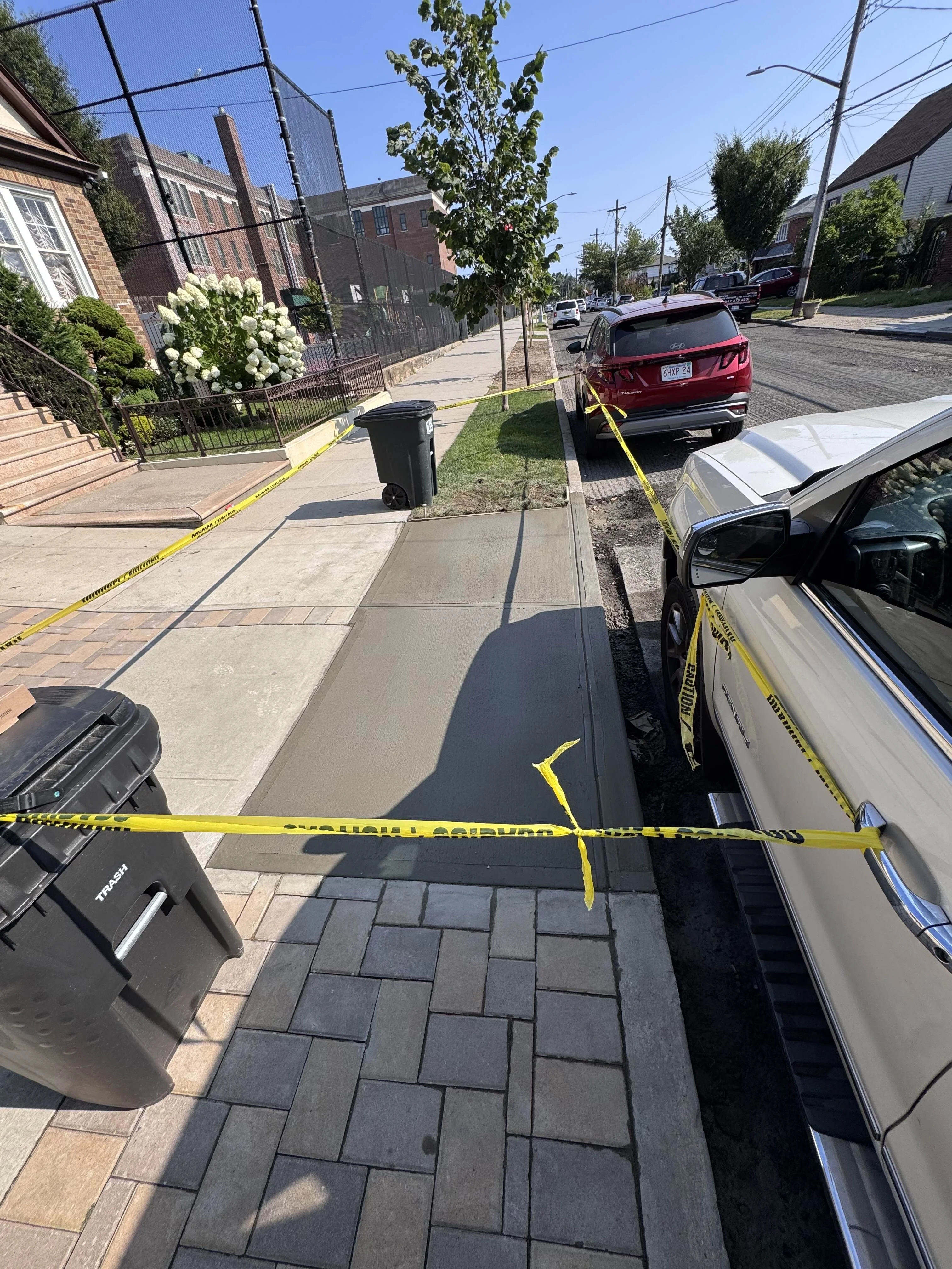 Concrete sidewalk with paver border in New York City