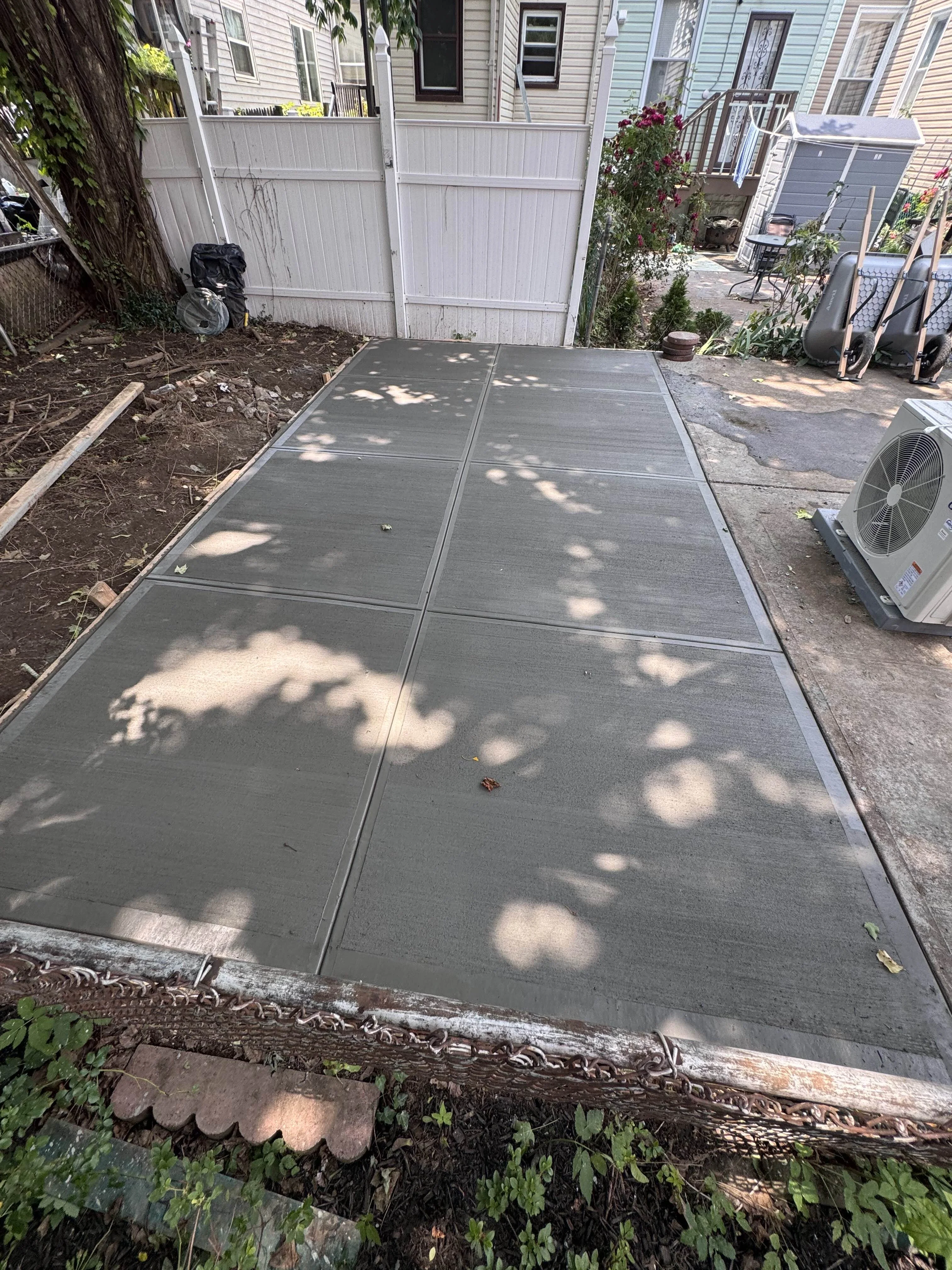 Backyard concrete slab walkway in New York City